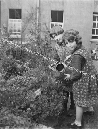 GIRLS WATERING FLOWERS